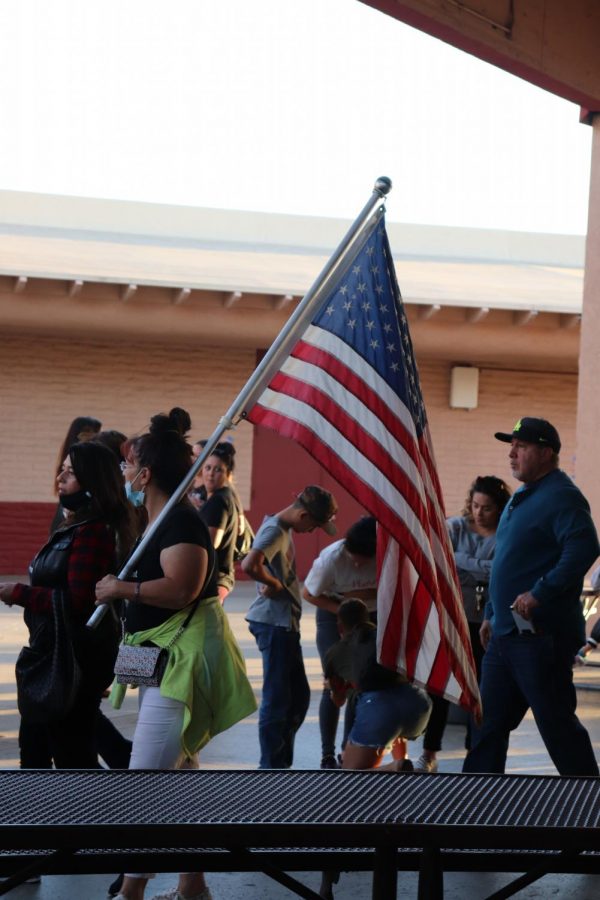 Parent carrying the American flag while attending the CVUSD Board Meeting 