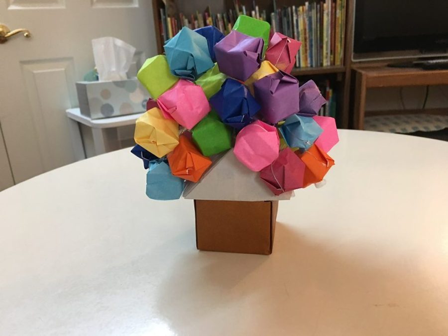 Origami club members competed against each other for who could fit the most origami balloons onto the houses they made. 
