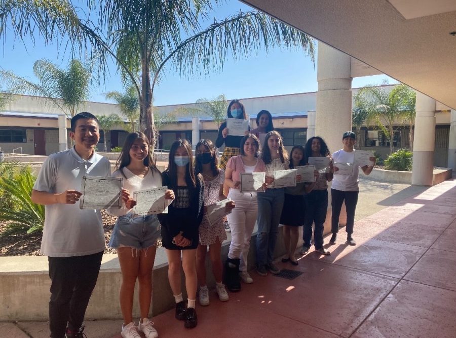 Pictured: Members of Positive School Culture Club (PSC) Daniel Choi (10), Frances Shu (10), Hannah Gu (10), and Ally Foo (10) hold their certificates of membership for the club