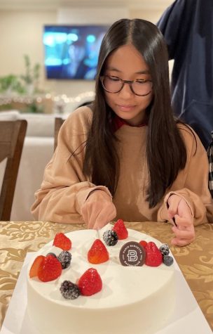 Kaitlyn Luu (9) cuts herself a slice of cake on her 14th birthday at Thanksgiving dinner. She spent her Thanksgiving break at her aunts house in San Jose with her mom and two siblings.