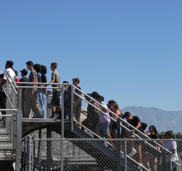 Despite extreme summer heat, Freshmen and Seniors (pictured) walk up the bleachers for the Pirates of the Caribbean kickoff rally. 