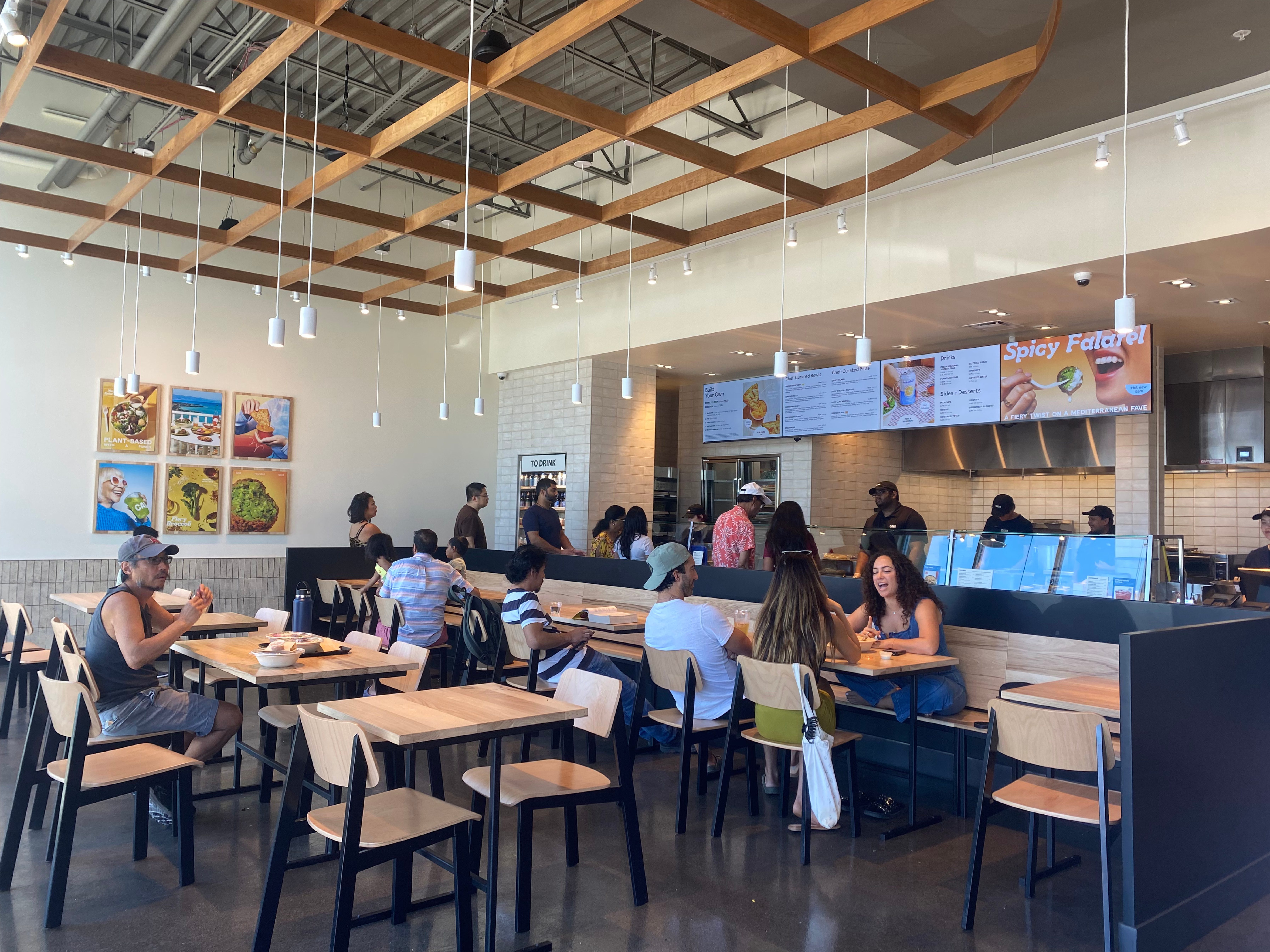 CAVA fills up with customers as lunch time rolls around. On Sunday, Aug. 27, families and friends gather at CAVA for Mediterranean food and quality time with one another. The line wraps around the store as customers line up to customize their bowls.
