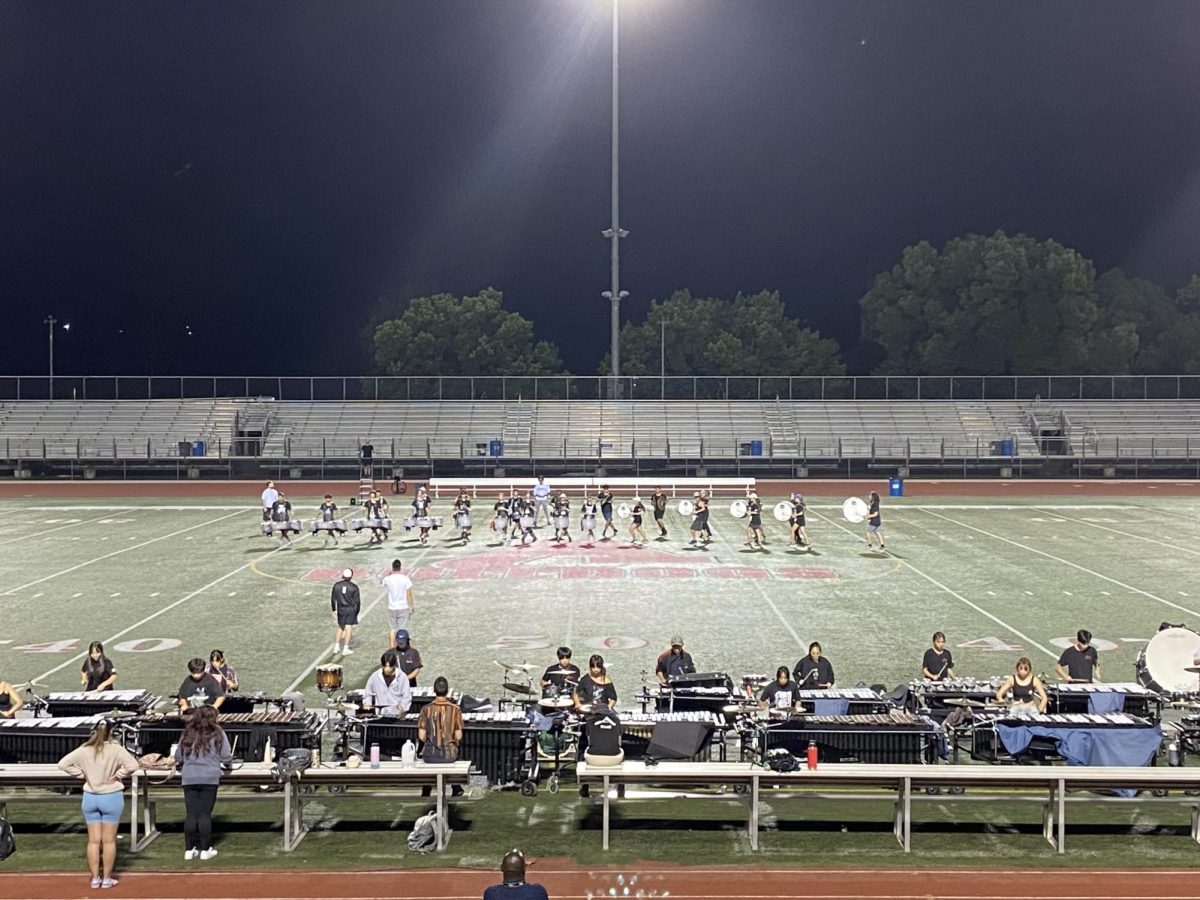 Th drumline ensemble practices late into the evening during the weekly night life sessions where parents and friends can watch in the stands. They repeat the same bars multiple times in order to perfect their pieces.