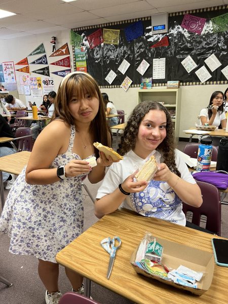 (From left) Mariam Senno (12) and Lindsay Shen (12) eats lunch in Ms. Park’s classroom to escape the summer heat. As temperatures rise and weather conditions change, many students seek shelter within teacher’s classrooms during lunch, risking potential messes their food might make.