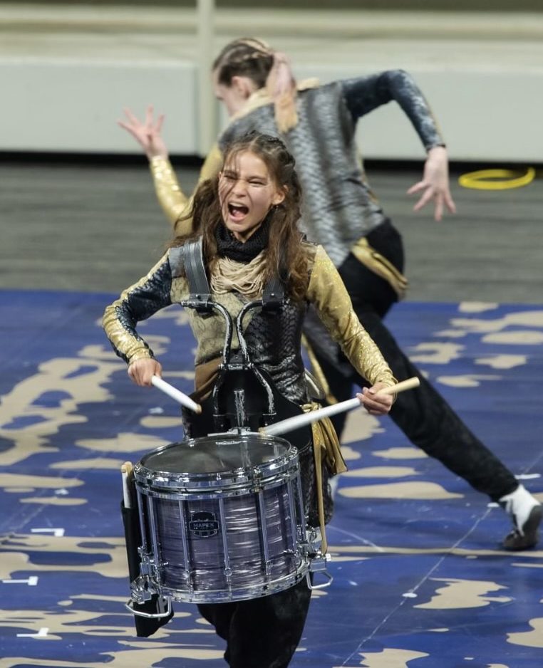 Hannah Courtney lights up the stage during the 2022 WGI Percussion regionals. Courtney is known her exceptional drumming technique and passionate storytelling.