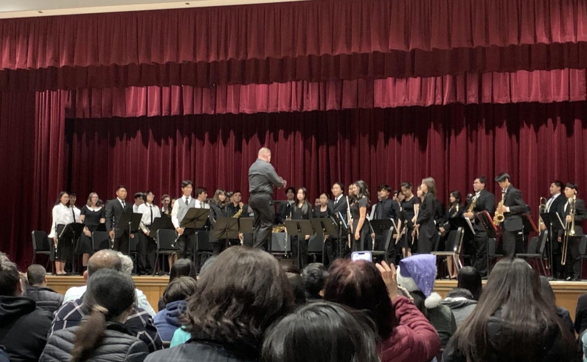 Mr. Trost conducts wind ensemble during the Thursdays Winter Music Concert. The concert served as a way for friends and family to celebrate the students dedication to music. 