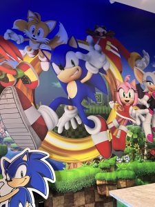 The interior of Sonic Speed Cafe includes a painted mural of Sonic the Hedgehog and his friends.