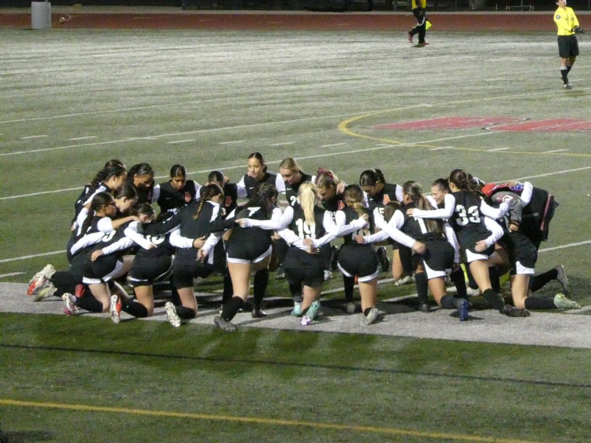 Girls Varsity Soccer team huddles together before their amazing game where they won 8-0 against Colony.