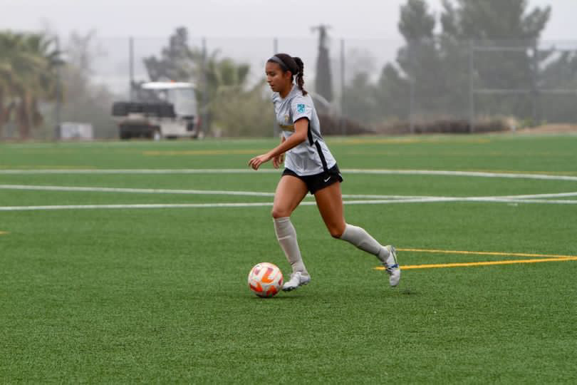 Isabella Contreras (above) in her club soccer team going for a goal during one of her seasons many games.