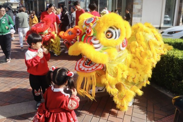 Chinese Club lion dancers meet audience members after performing their routine at the Chinese New Year Gala in The Shoppes. The club hopes to educate the community about Chinese traditions through their performances.