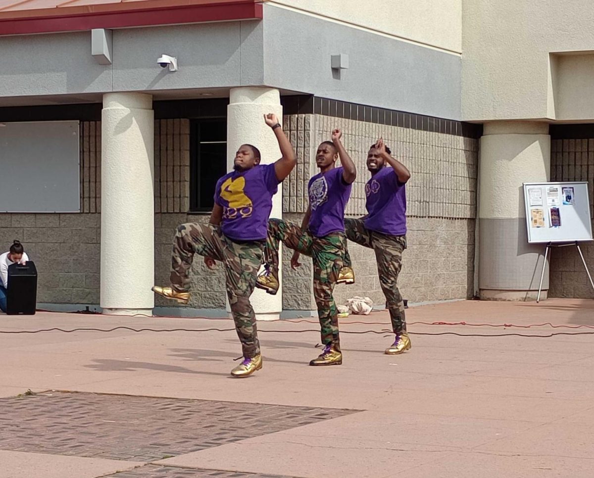 A college fraternity, Omega Psi Phi, performing on the library stage to show their culture to students during Black History Month.