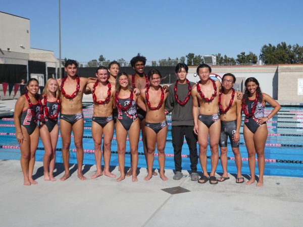 (From left to right) Seniors Victoria Rivas, Sydney Rich, Julian Juarez, Tyler Johnson, Ben Trull, Angelina Hernandez, Donovan Thomas, Alexander Florentinus, Nathan Cheng, Ryan Chen, Joshua Chan, and Roseanna Ashak line up in front of the pool as the friends, parents, teammates, and coaches commemorate the Bulldogs.
