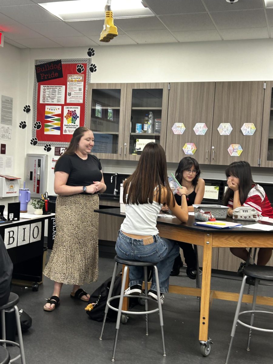 Mrs. Katlyn Trevino proudly observes her class during a biology experiment. Her class is described as engaging and fun by her students, and her smile brings joy even to biology experiments. 