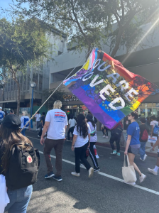 Participants holding up supportive signs during the 2024 AIDS Walk.