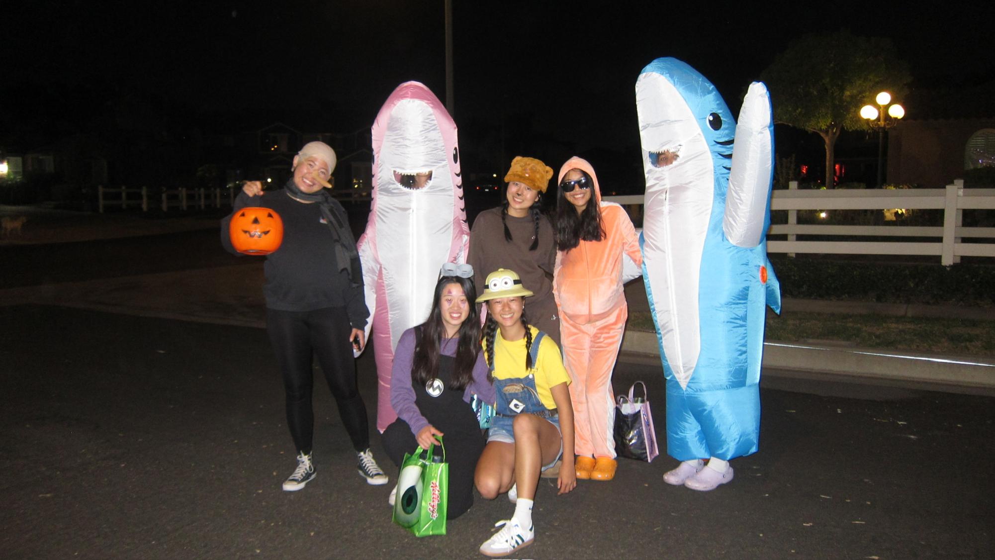 From left, Cayenne Lo (11), Ashley Chang (11), Elisabeth Lee (11), Audris Yueh (11), Cassie Du (11), Eva Acantara (11), Elisabeth Lee (11), and Priya Devine (11) gather together for Halloween. Halloween marks a day of fun, terror, and mystery. Students come to school and spend the night in costumes ranging from fan-favorite cartoon characters to dark classics like witches or ghosts.