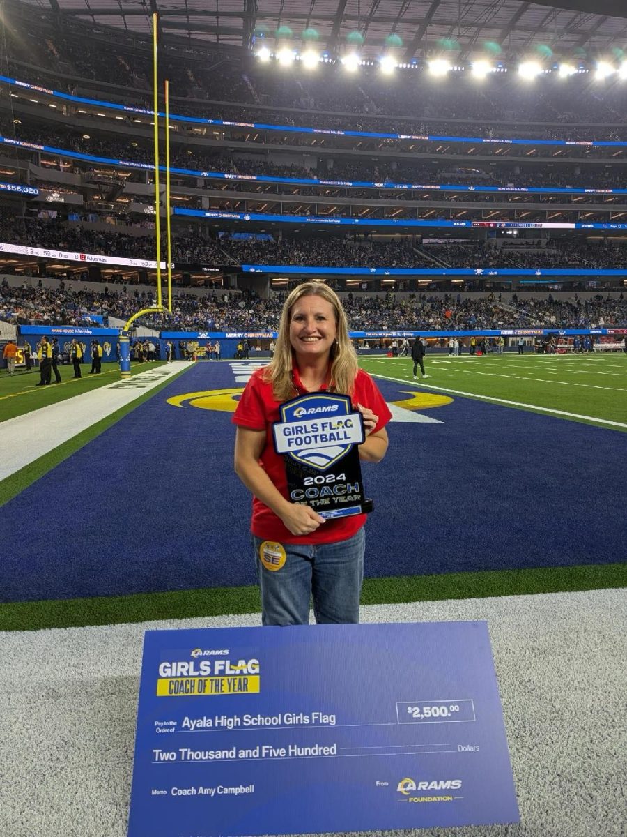 Coach Amy Campbell takes a picture with her award and certificate at the Rams Stadium located in Los Angeles. Despite being a recent addition to Ayala's sports department, dedicated individuals including Coach Campbell have helped the growing sport become even larger over the course of this year's season.