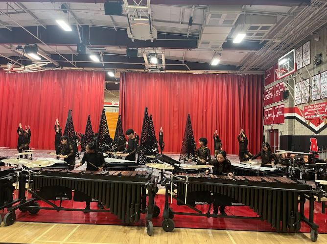 The percussion ensemble performs their melodic tunes while visual ensemble demonstrates their visual performance using props for the upcoming season at the percussion parent preview. 