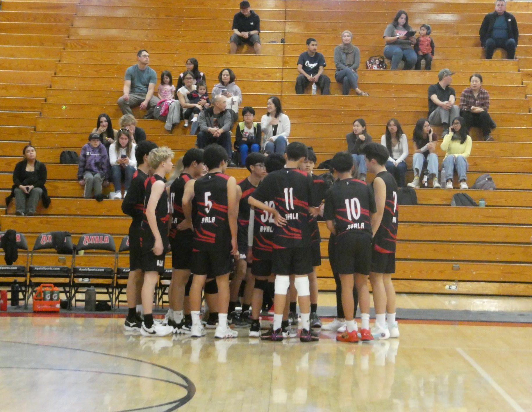 Ayala's Boys Junior Varsity team huddles up during one of the timeouts, discussing what they can do to improve their skills. 