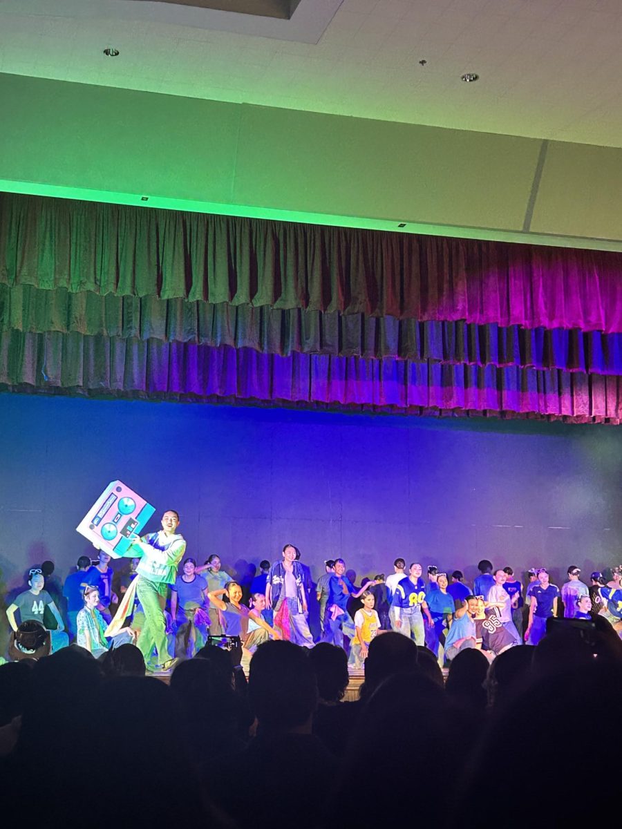 Beginning Dance performs "90's Throwback" with a colorful boombox prop and the dancers all dressed in retro style clothes. The dances were all well incorporated with the theme, throwback, and truly put the audience back in time.
