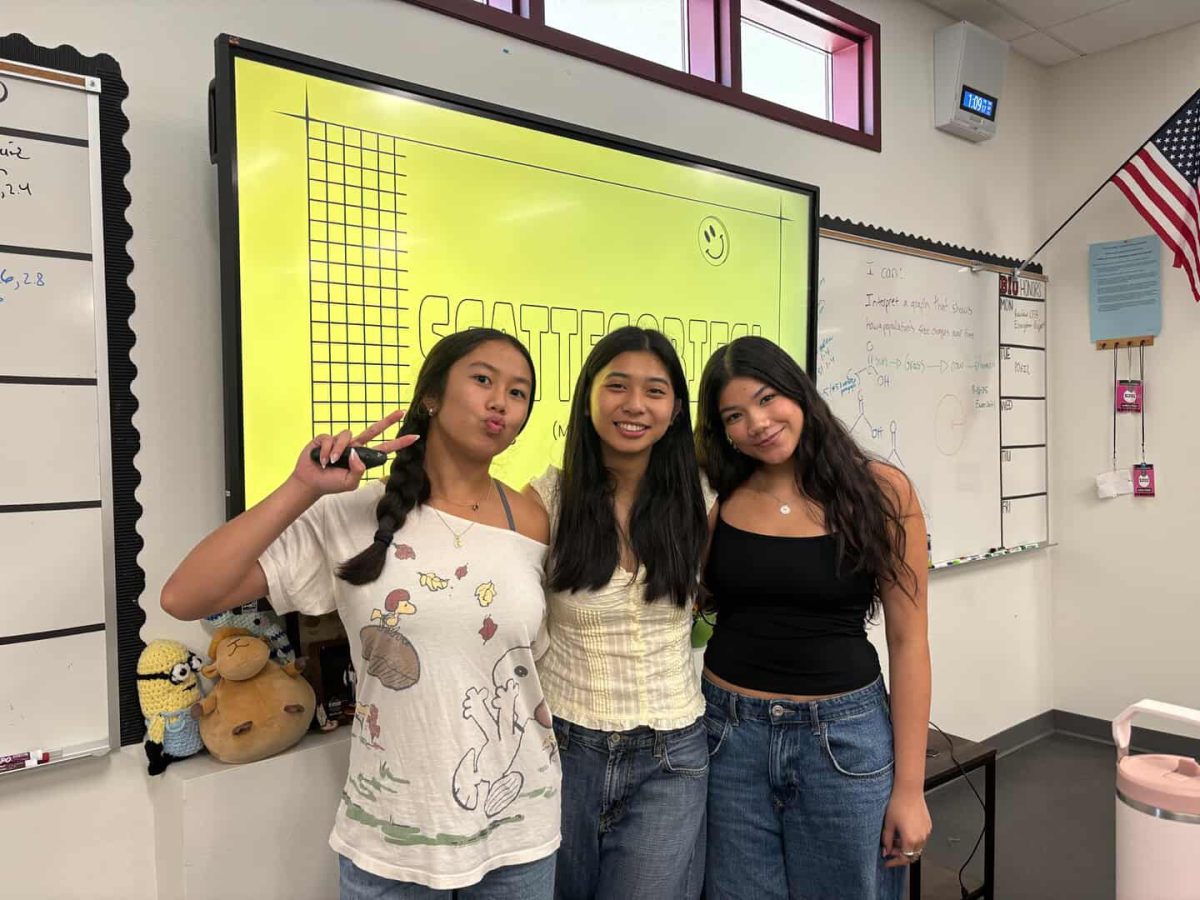 Social Media Manager Hailey Placé (12), Secretary Gaby Ladrido (12), and Tech Team member Reagan Ruiz (12) pose for a picture to celebrate the start of a new year for the Positive School Culture Club. 