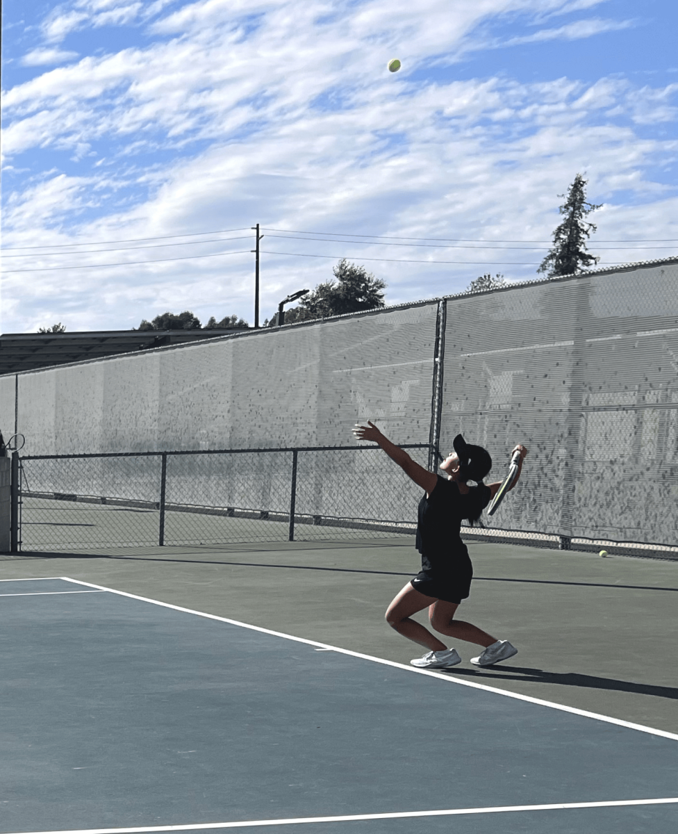 Hailey Liu (9) prepares to serve the ball before she gives it an energetic whack of her racket getting it over the fence starting the match. She serves for her match during Ayala's JV tennis match on 923 where unfortunately they lost with a 5-13 score. 