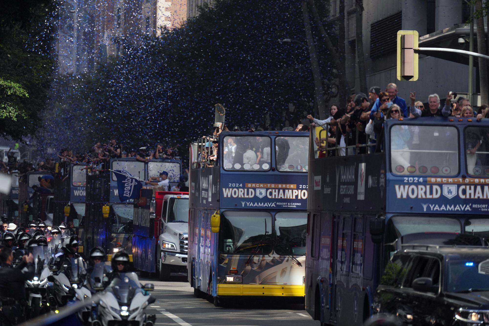 On November 3, the Los Angeles Dodgers players and coaches ride double-deck buses during the World Series championship parade and celebration. 