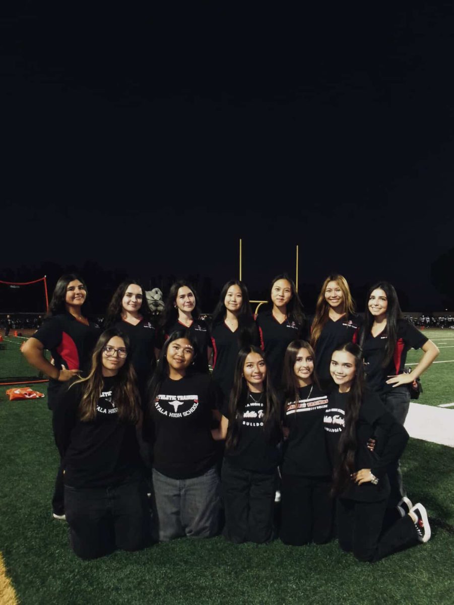 Ayala's very own athletic trainers stand together as a team on the football field, all smiling together with friendships built from long practices and busy game nights. They take pride in Ayala through the care of their athletes.