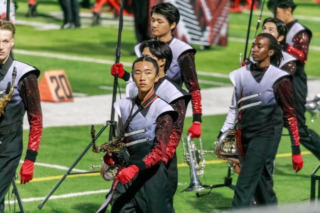 Woodwind Captain Khai Dinh (11) is pictured playing the saxophone in a Band and Colorguard performance.