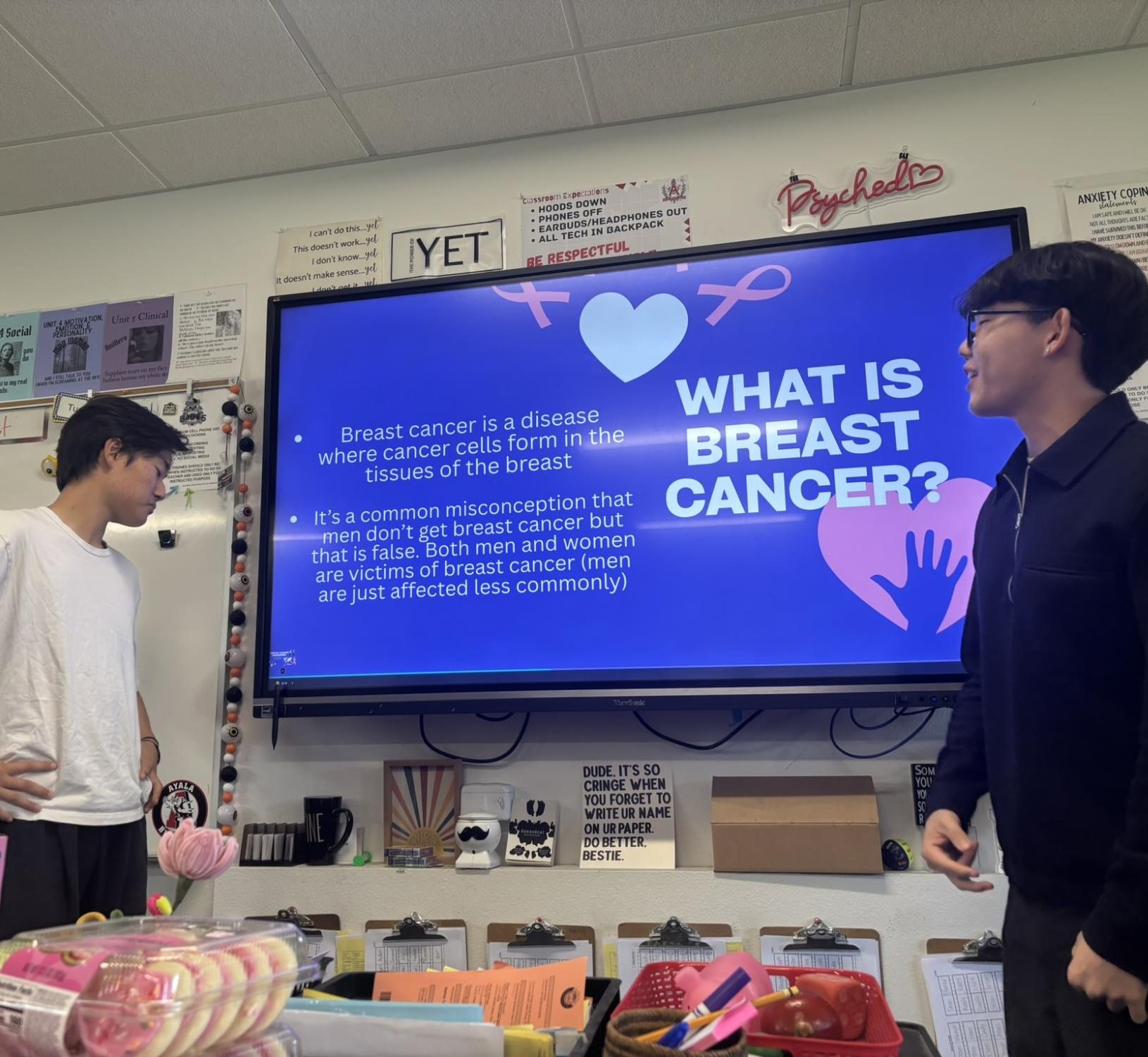 The Bridge of Ages Club gets started with their presentation, as they talk about breast cancer in breast cancer awareness month and its relevancy with the elderly. From left, Daniel Choi (10), the treasurer, and Matthew Kim (11), the president, are depicted guiding these meetings and engaging their members.