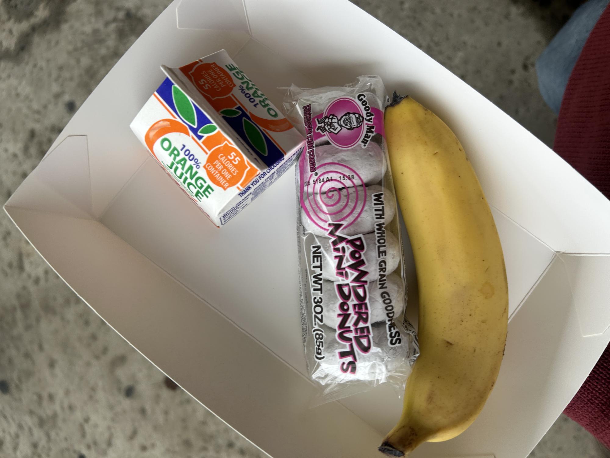 A typical school lunch consists of a drink, fruit or veggie, and the main entree.