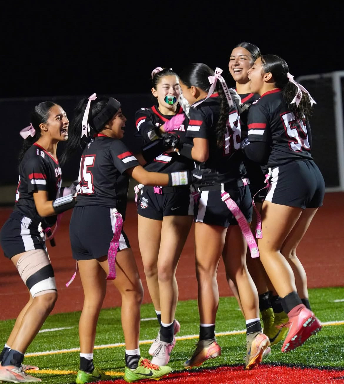 Ayala girls flag football enthusiastically celebrates a big play in the end zone.