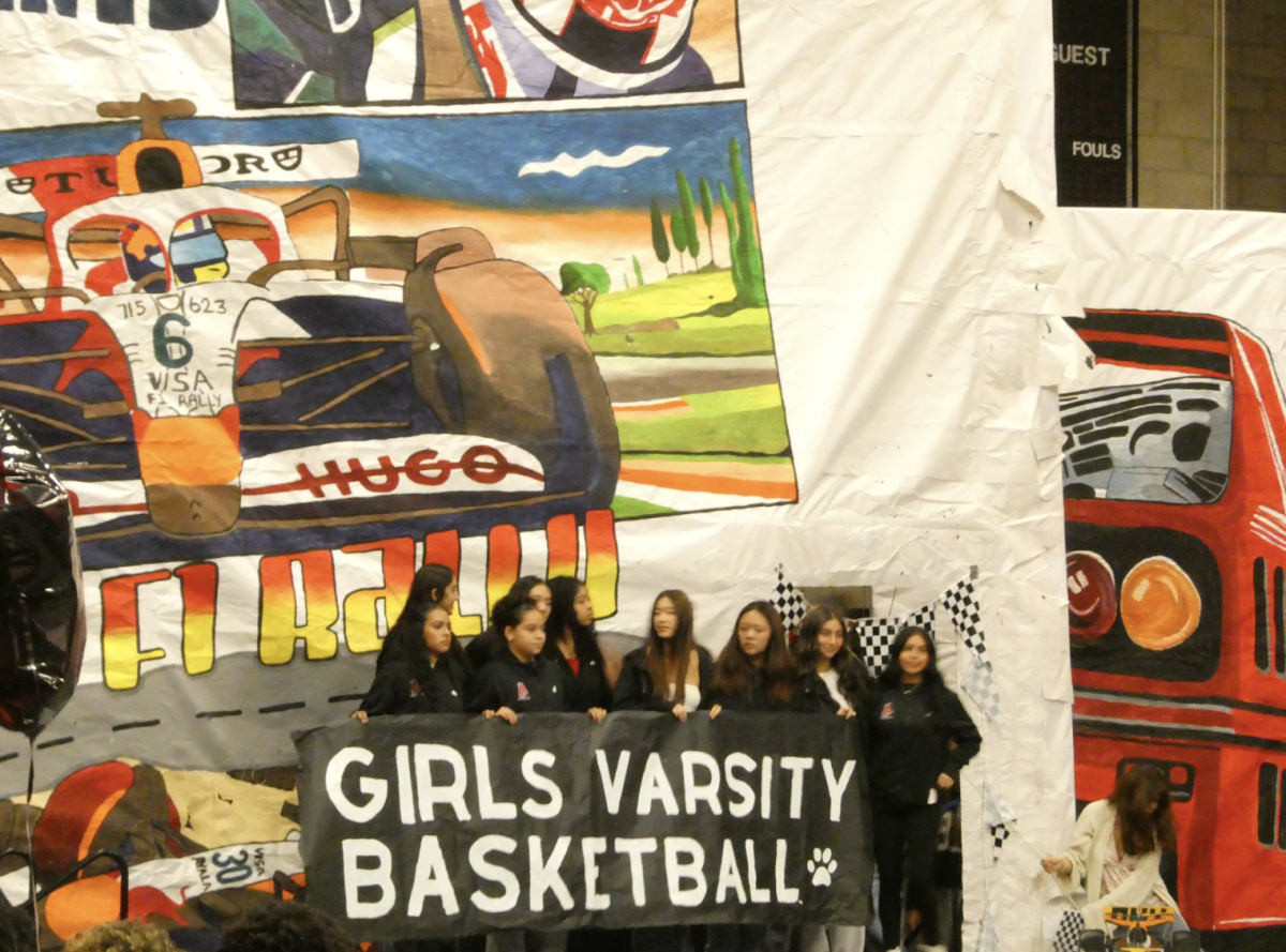 Girls basketball is recognized on stage. 