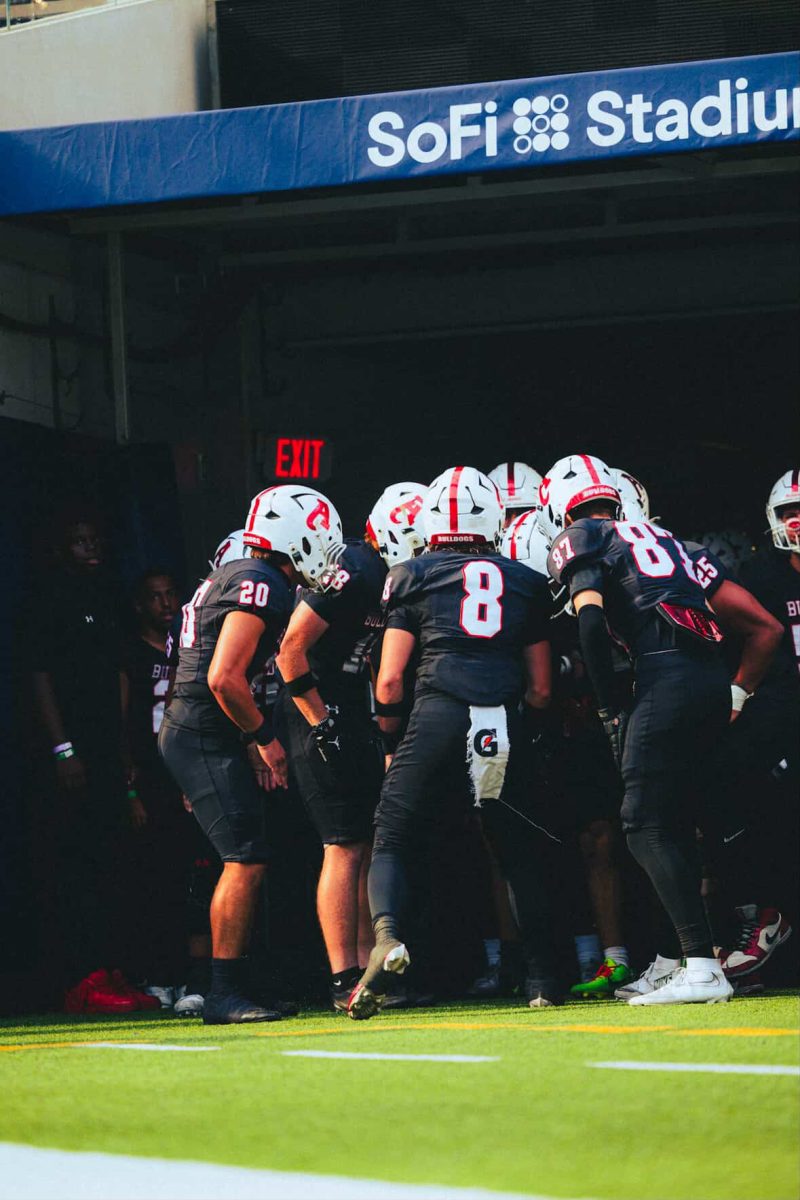 Dakota Bostek (#8), Nolan Walker (#87), Mason Eligio (#20), and Blake Frausto (#18), huddling up and getting hype before their week one matchup against Summit High School.