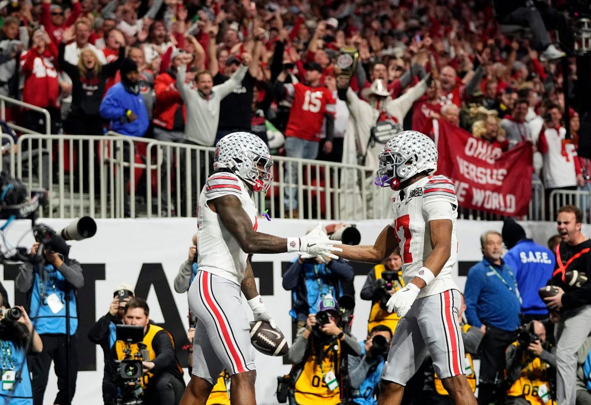 Ohio State Buckeyes wide receiver Jeremiah Smith (4) celebrates with Ohio State Buckeyes wide receiver Carnell Tate (17) after a touchdown catch against Notre Dame Fighting Irish in the first quarter during the College Football Playoff National Championship at Mercedes-Benz Stadium in Atlanta on January 20, 2025. 