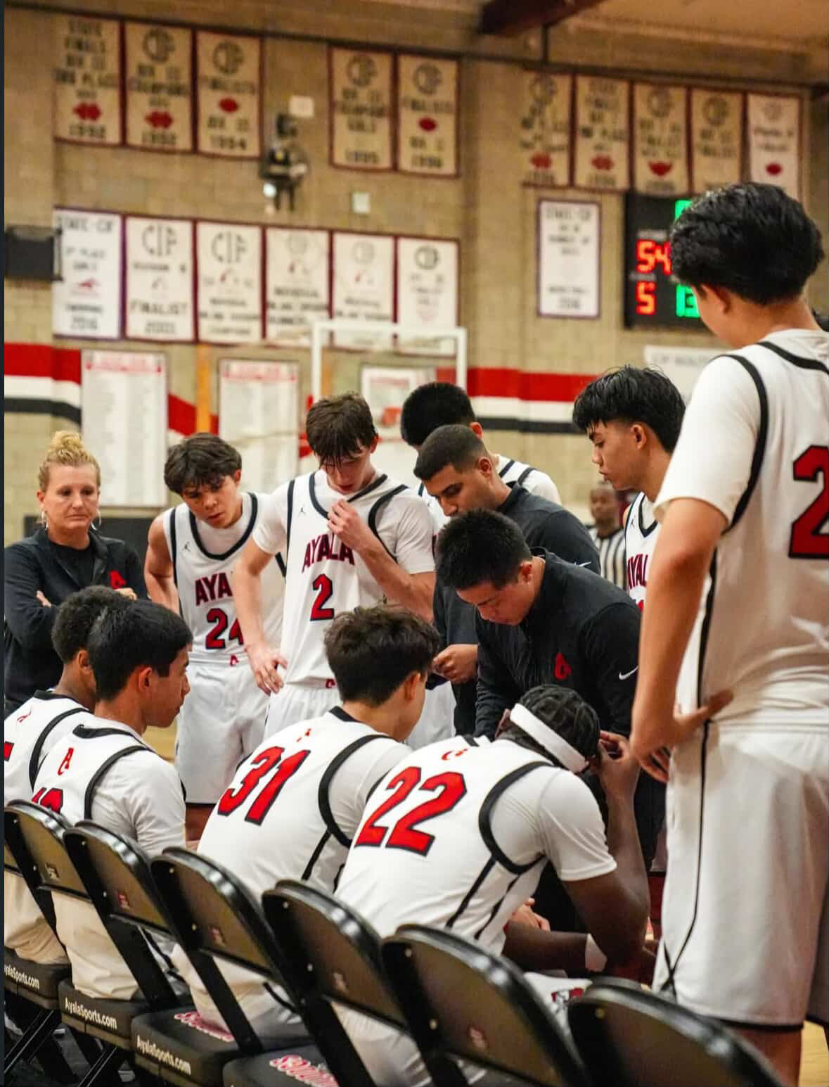 Coach Bhatt and the Bulldogs seen drawing up a play during a timeout.