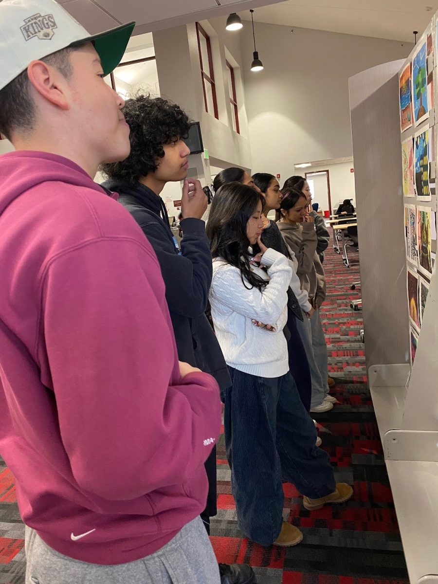 Students look on, enraptured as they take in the different pieces of art displayed. They are transferred to another world as they observe, seeing through the eyes of the artist, as the showcase intends to. “[Students] can see what other people think through their drawing and how all minds work,” Fiorella Arboleda (12) said. 