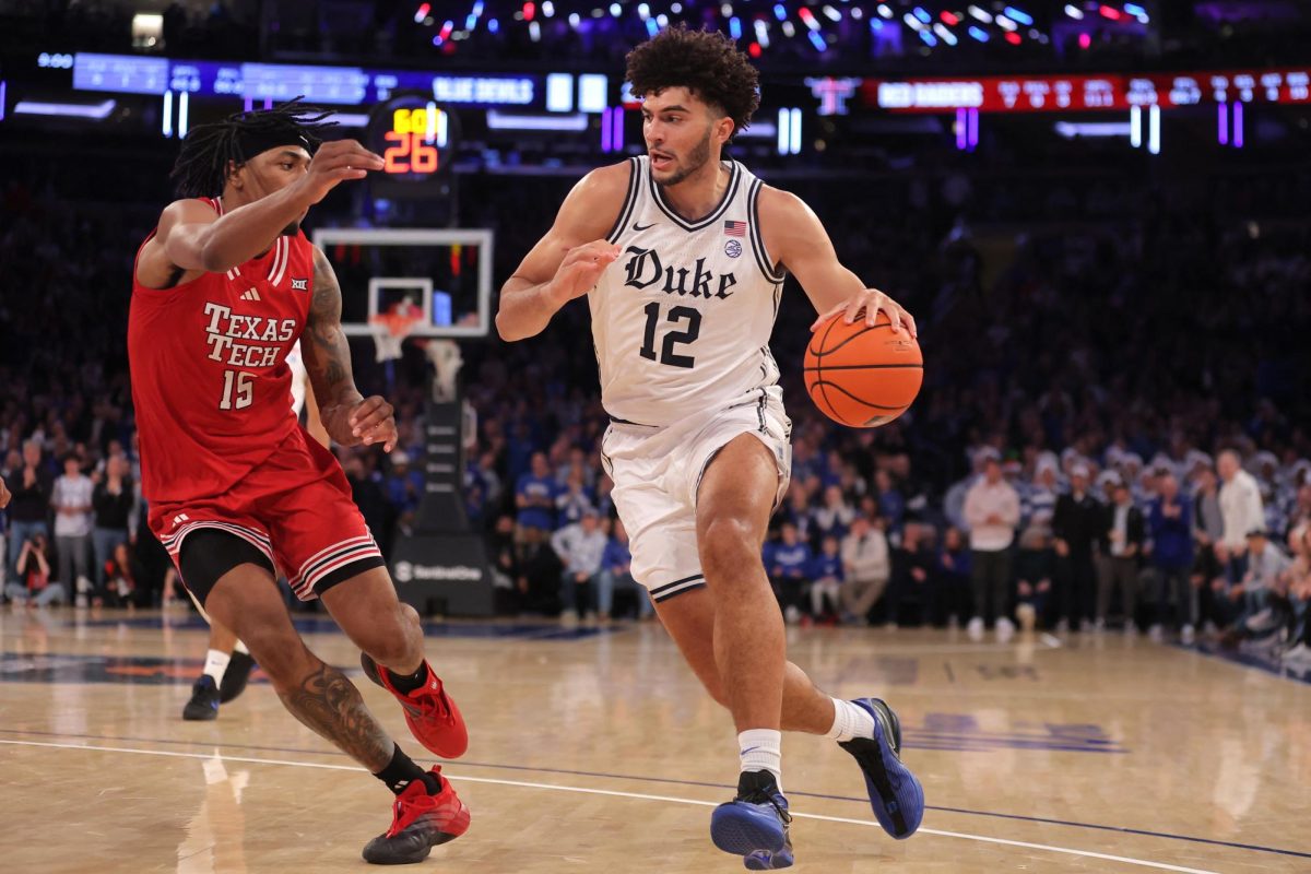 Dec 20, 2025; New York, New York, USA; Duke Blue Devils forward Cameron Boozer (12) drives to the basket against Texas Tech Red Raiders forward JT Toppin (15) during the first half at Madison Square Garden.