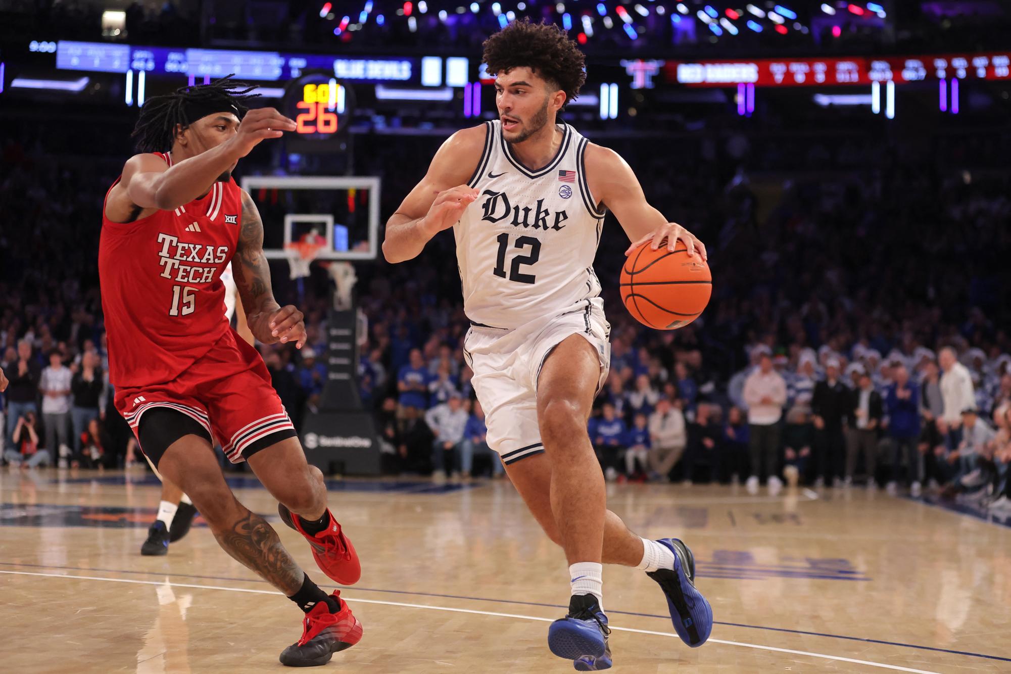 Dec 20, 2025; New York, New York, USA; Duke Blue Devils forward Cameron Boozer (12) drives to the basket against Texas Tech Red Raiders forward JT Toppin (15) during the first half at Madison Square Garden.