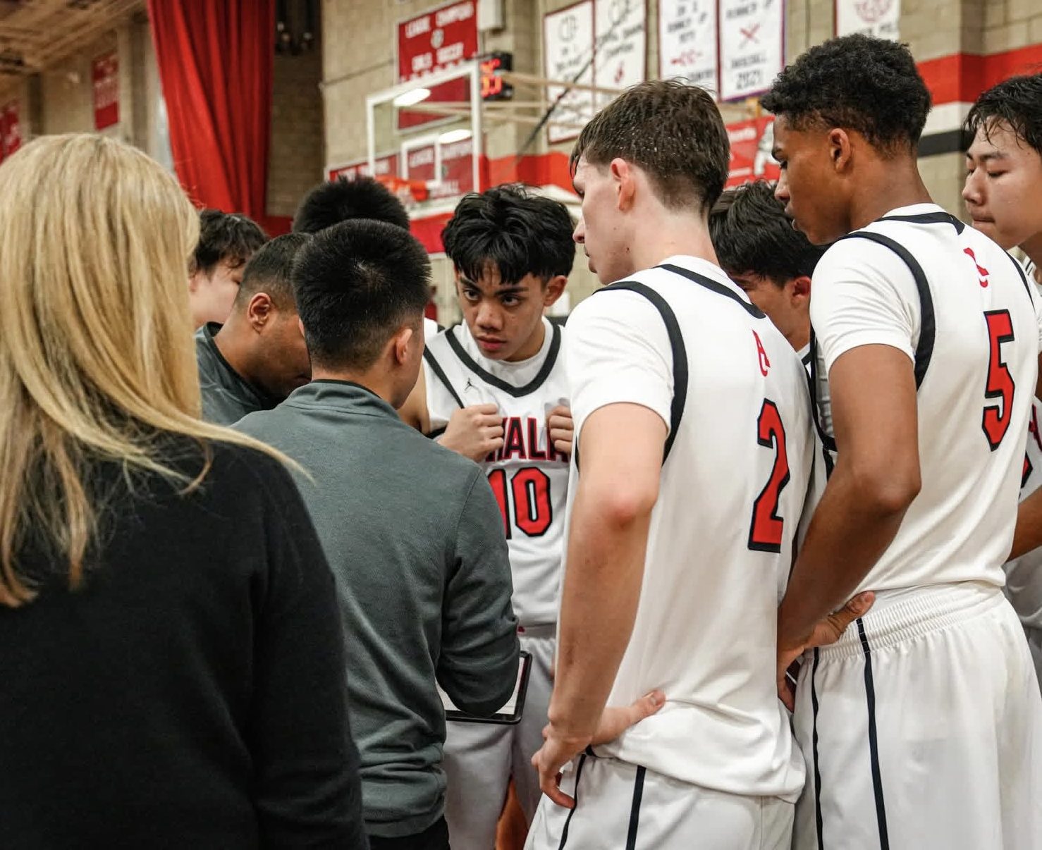 The Bulldog basketball players huddle up during an important timeout during the closing stretch of the game 