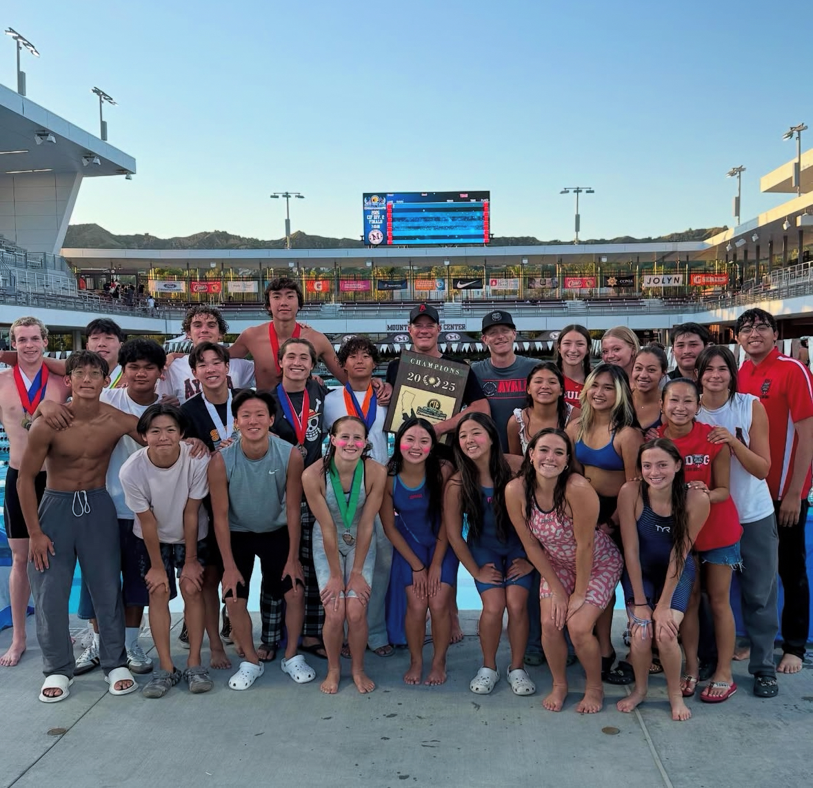 Ayala's swim and dive Varsity teams after jumping into the pool to celebrate their massive league win during the previous season. Now going into 2026, the Bulldogs look to win another league victory.