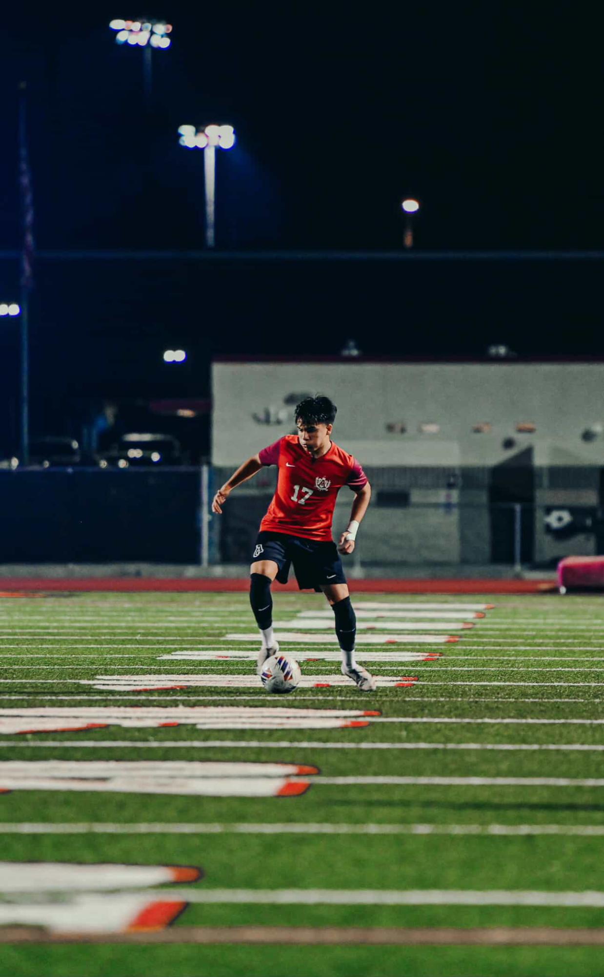 Max Sumner (11) maintains possession of the ball during a Bulldogs' home soccer game. 