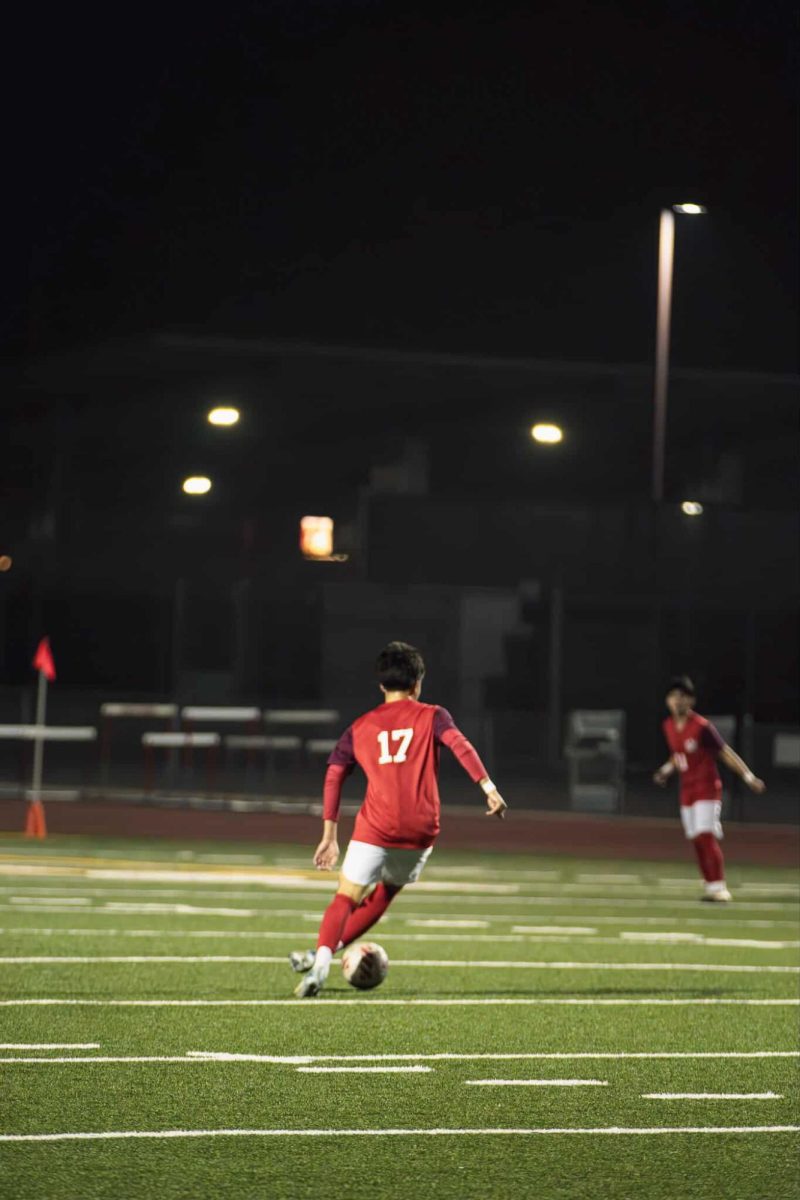 Max Sumner dribbles the ball down the field as he looks for an open teammate 