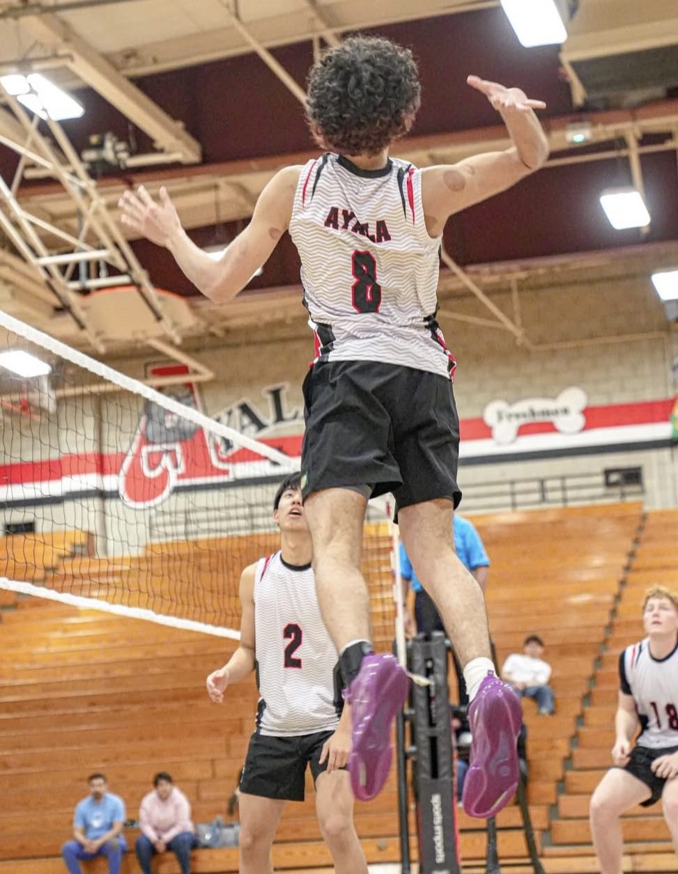 Senior Aiden Coronel jumping up preparing to spike down the ball against Ganesha High School.