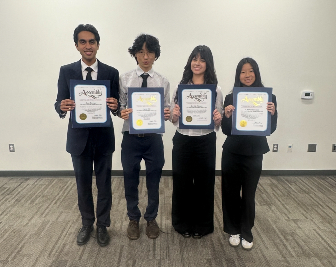 From left, Don Kumar (11), Lucas Liu (11), Sophia Horan (10), and Charlotte Chen (9) after the panel ended with their certificates.
