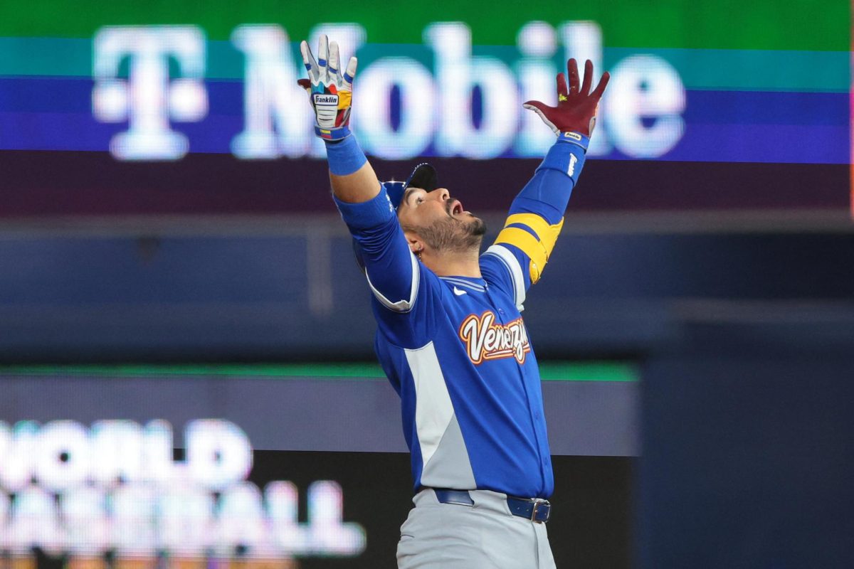 Venezuela third baseman Eugenio Suarez (7) reacts after hitting a RBI double against the United States in the ninth inning during the 2026 World Baseball Classic Championship game at loanDepot Park.