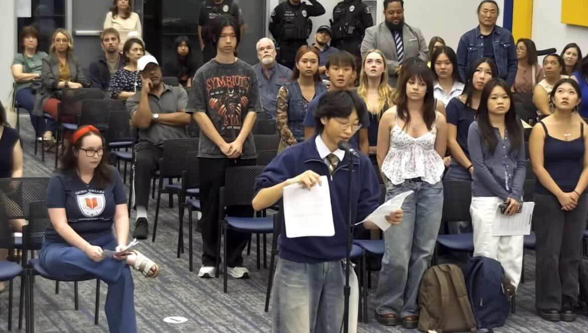 Lucas Liu (11) holds up the petition signed by over 350 students to present to the board and the recent board meeting.