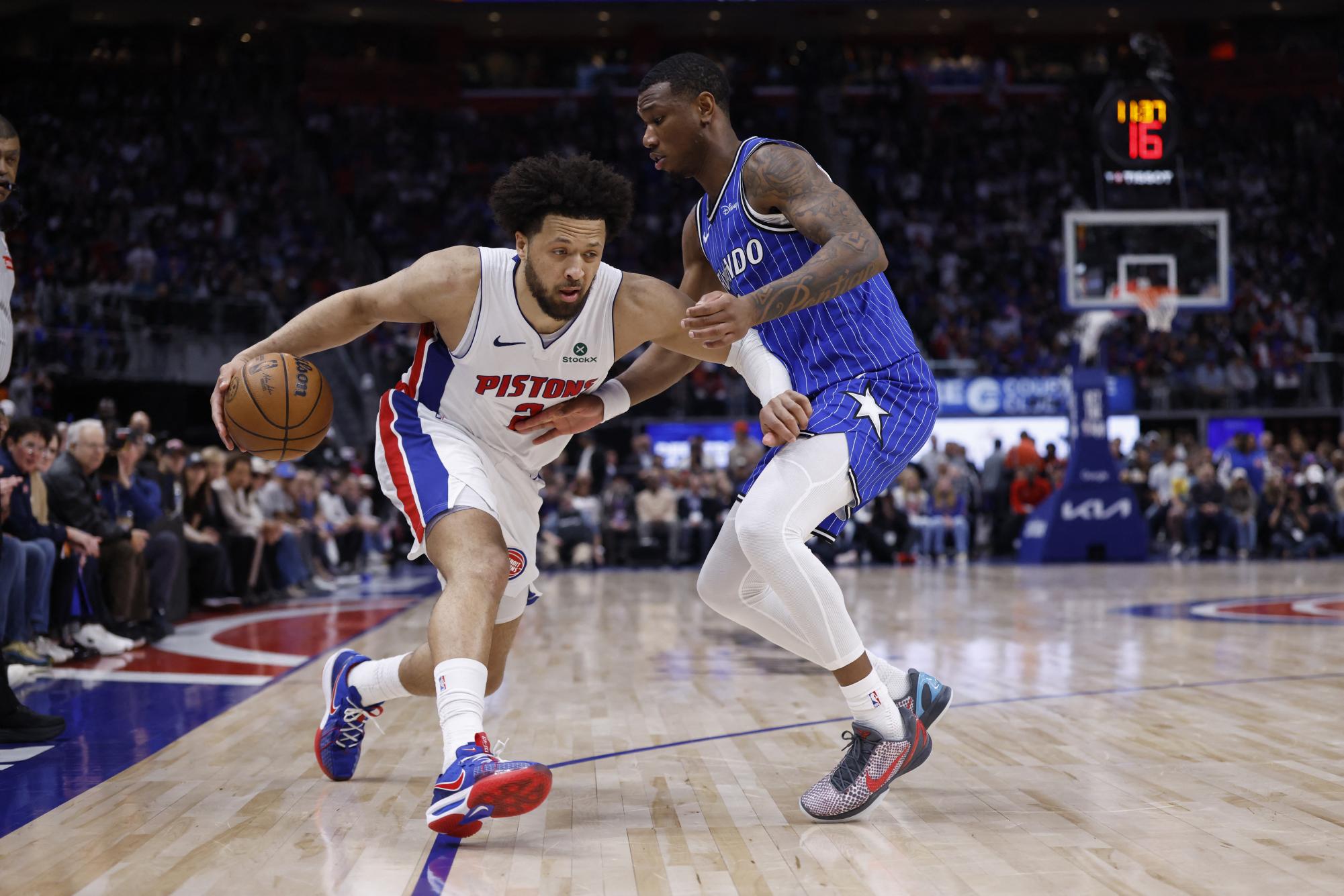 Detroit Pistons guard Cade Cunningham (2) dribbles defended by Orlando Magic forward Jamal Cain (8) in the second half during game seven of the first round of the 2026 NBA Playoffs at Little Caesars Arena.